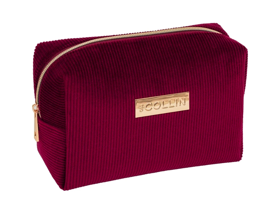 Trousse de soins en velours côtelé rouge avec fermeture éclair dorée pour transporter des produits de beauté.